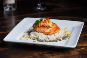 Salmon en Huitlacoche. Pan seared, then baked to tender, flaky perfection this fresh salmon is topped with huitlacoche sauce and mango-papaya salsa